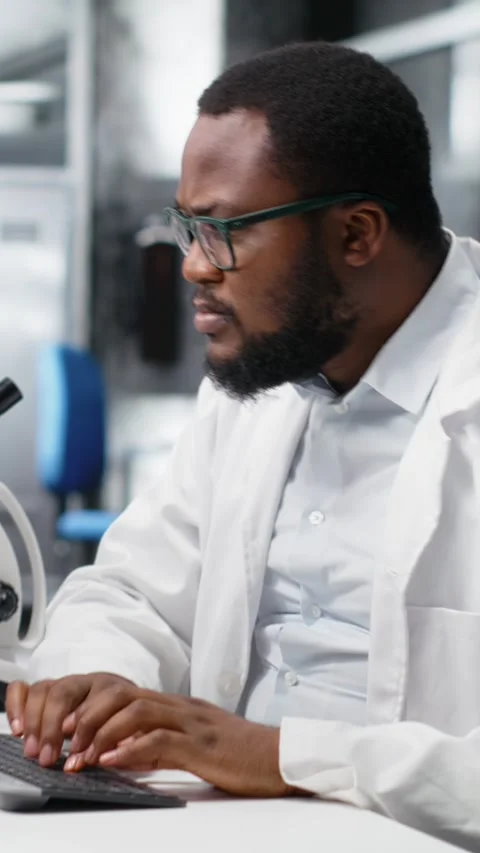 Vertical video Laboratory worker squinting eyes at computer, struggling to Stock Footage 319505930