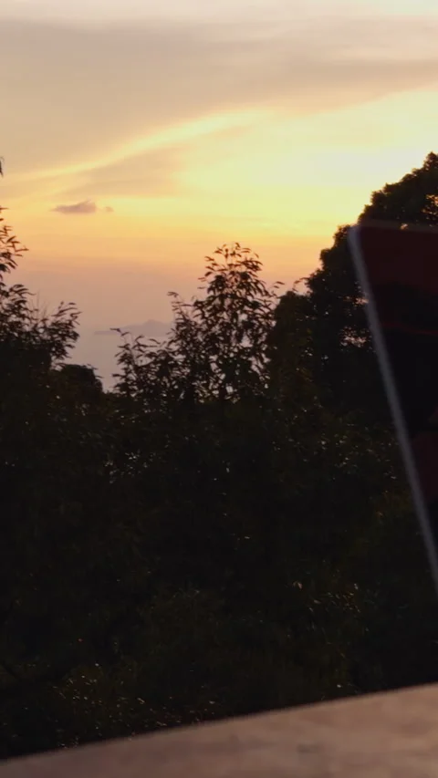 Vertical video. Laptop And Drink On Wooden Table With Sunset Landscape, Camera S Stock Footage 334310652