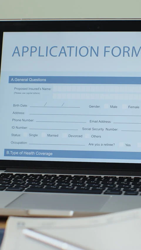 Vertical video. Laptop computer with an Application Form on its display. Video stock 343761415
