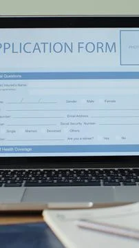 Vertical video. Laptop computer with an Application Form on its display. Stock Photos