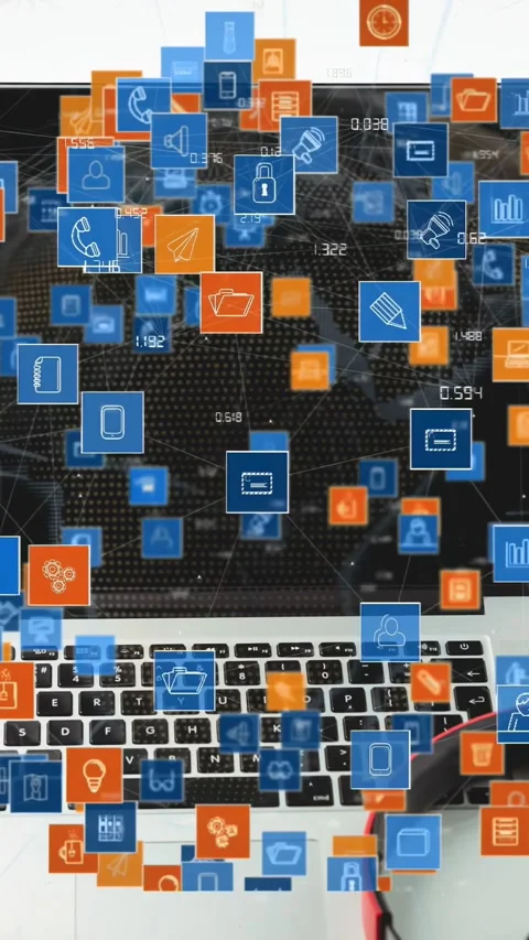 Vertical video: Laptop getting data on desk, blue icons forming network over Stock Footage 330509574
