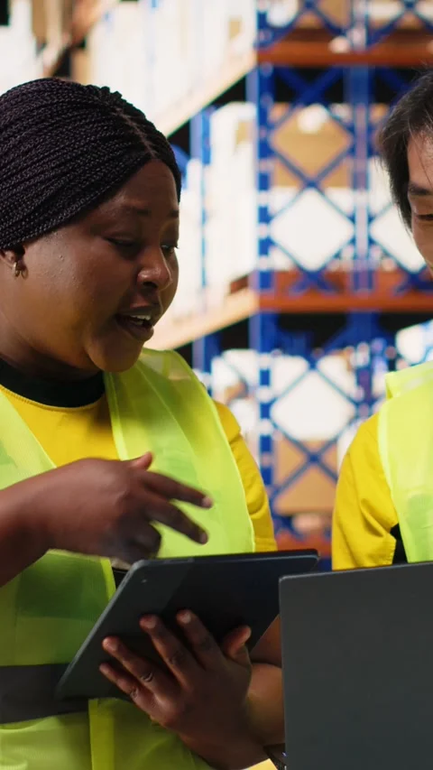 Vertical Video Large scale warehouse team manages e-commerce order processing Stock Footage 312578937