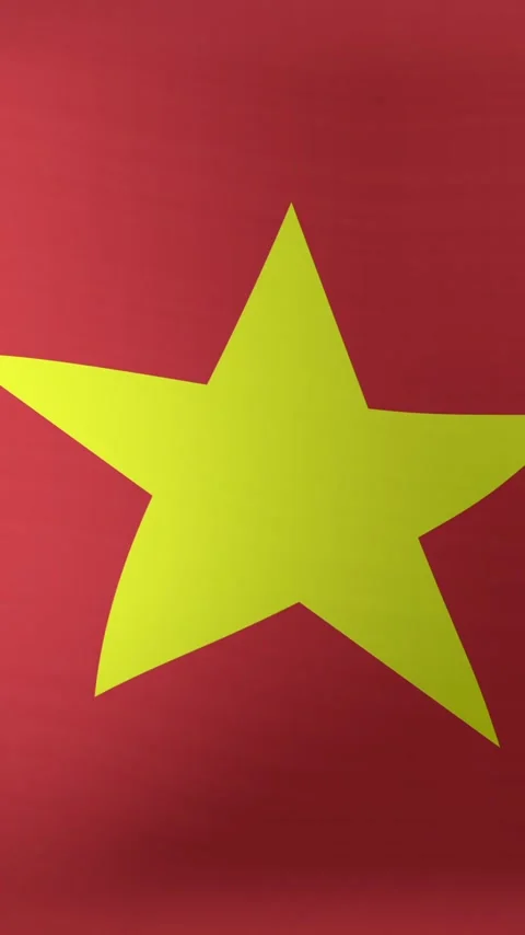 Vertical video: Large yellow star shifting left and right on red fabric, breeze Stock Footage 348384418