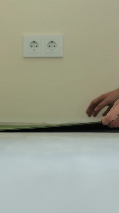 Vertical video Laying underlay for the laminate flooring. . Stock Footage 339060167