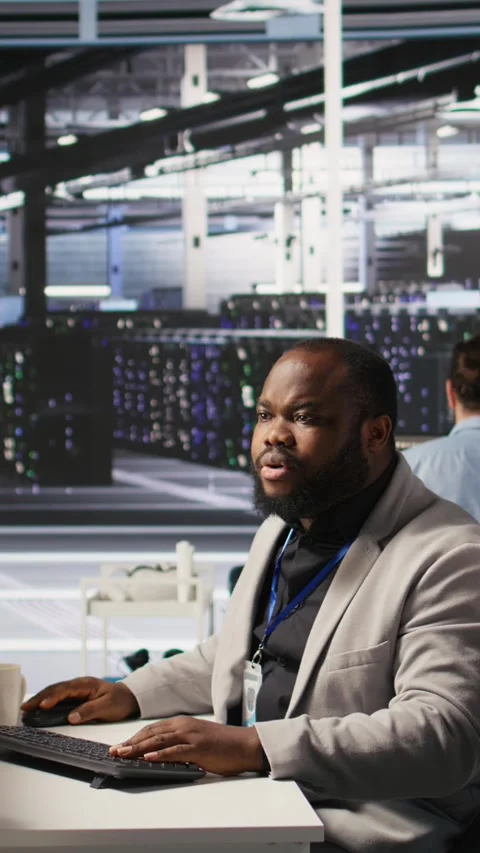 Vertical video Lead data center technician overseeing team integrating AI Stock Footage 309251853