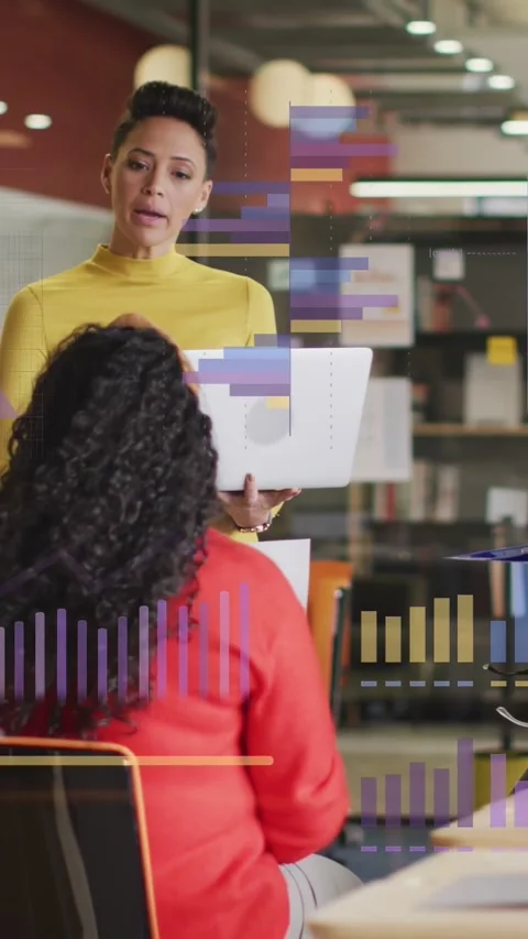 Vertical video: Lead holding PC showing charts as peer tapping tablet, man Stock Footage 333487288