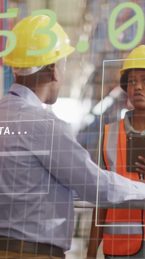 Vertical video: Lead pointing at tablet, tech in warehouse tapping, green data Stock Footage 333479907