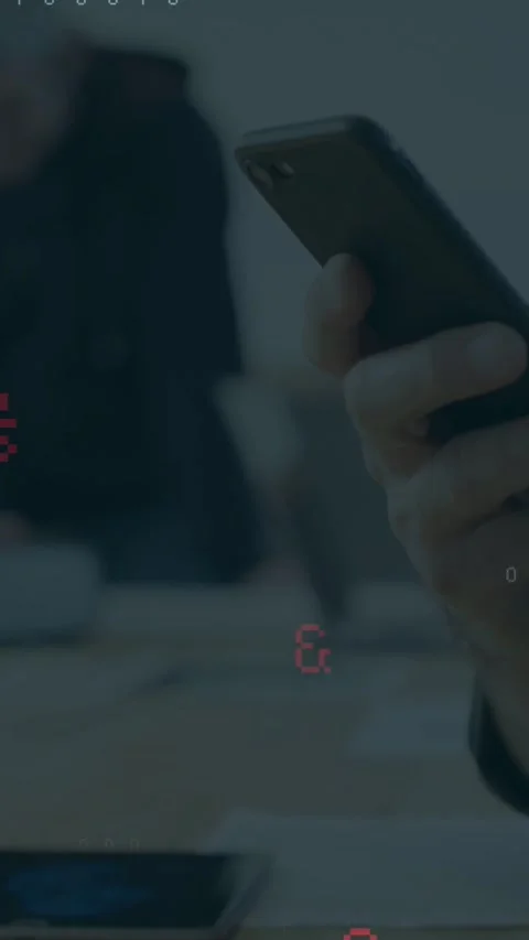 Vertical video: Lead scrolling phone in tech meeting, showing code overlays for Stock Footage 331128882