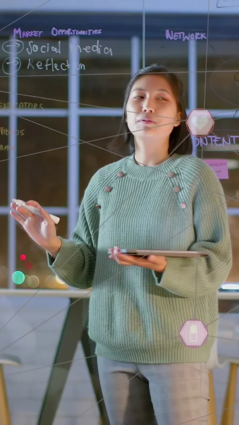 Vertical video: Lead tapping tablet drawing network on glass showing animated Stock Footage 333464842