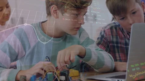 Vertical video: Leaning boy in striped tee testing kit in class, viewing laptop, Stock Footage 333035410