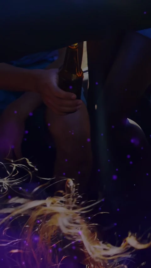 Vertical video: Leaning man passing beer bottles under low sofa to share drinks, Stock Footage 332381902