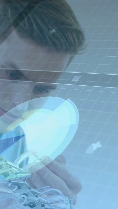Vertical video: Leaning in, technician examining and adjusting robotic hand for Stock Footage 332594948