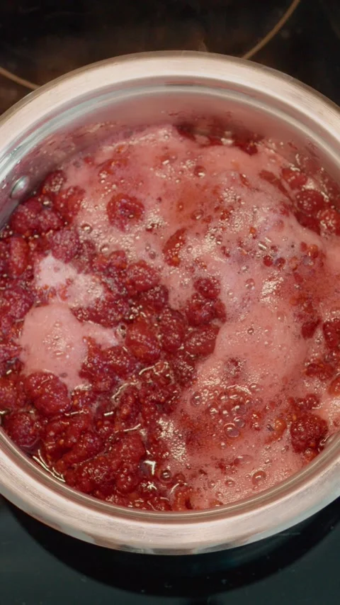 Vertical video Learn to make homemade raspberry jam by boiling fresh raspberries Stock Footage 323361826