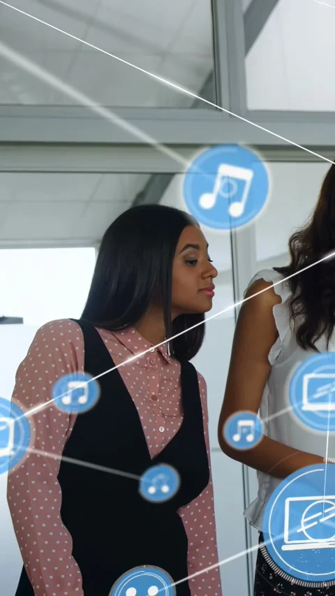 Vertical video: Left colleague leaning, right colleague gesturing, demoing tech Stock Footage 333692233
