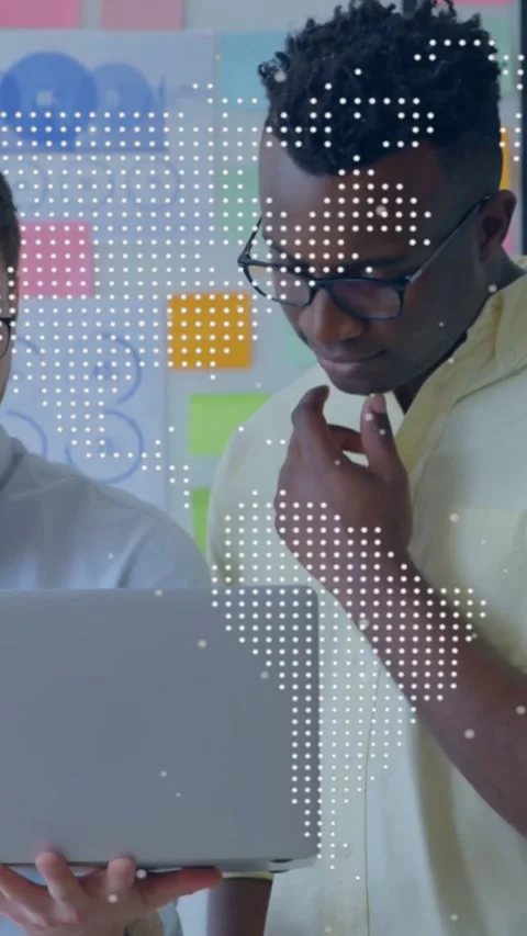 Vertical video: Left man tilting laptop, two men reviewing business plan, map Stock Footage 334392002