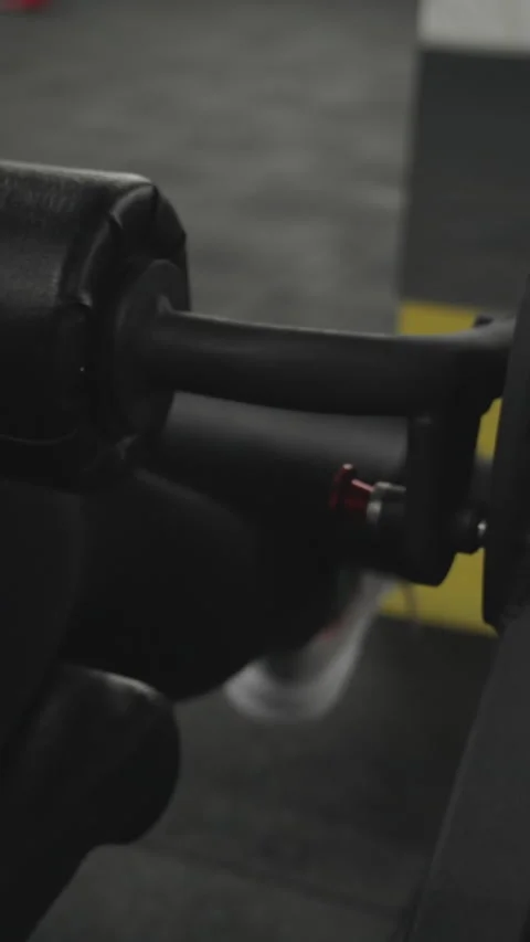 Vertical video. Leg extension on a machine is an isolating exercise for the quad Stock Footage 255298739