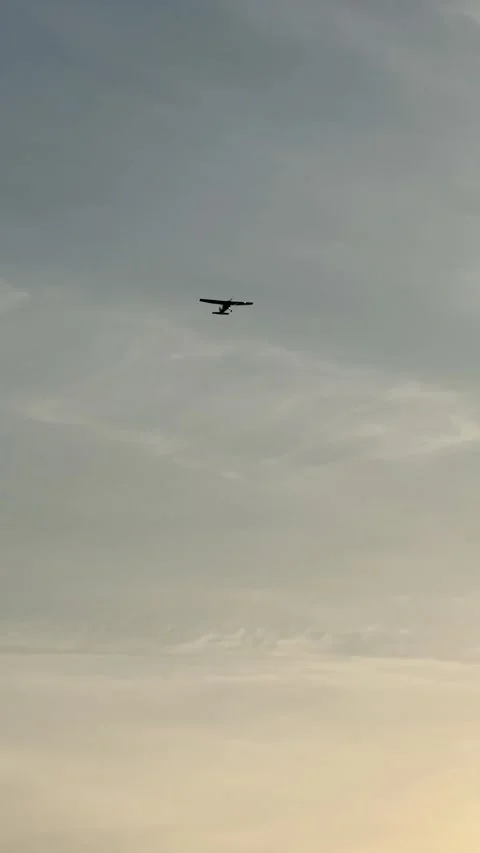 Vertical video: light aircraft flying overhead Stock Footage 314797972