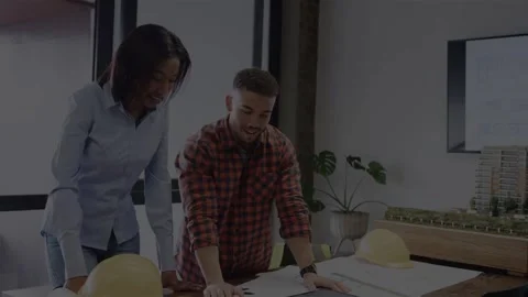 Vertical video: Light shifting, woman and man in shirts studying plans at desk Stock Footage 332865962