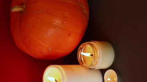 Vertical Video. lighted candles with pumpking on table. Halloween atmosphere Stock Footage 147893334