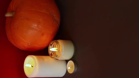 Vertical Video. lighted candles with pumpking on table. Halloween atmosphere Stock Footage 147893398