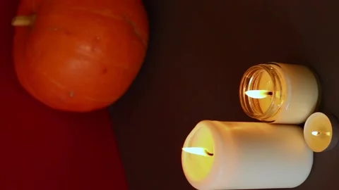 Vertical Video. lighted candles with pumpking on table. Halloween atmosphere Stock Footage 147893513