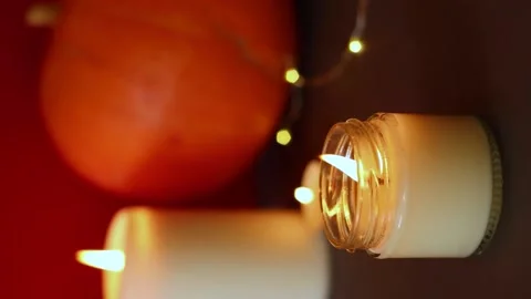 Vertical Video. lighted candles with pumpking on table. Halloween atmosphere Stock Footage 147893728