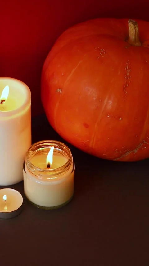 Vertical Video. lighted candles with pumpking on table. Halloween atmosphere Video stock 152446243