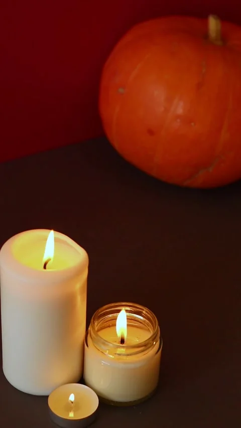 Vertical Video. lighted candles with pumpking on table. Halloween atmosphere Video stock 152446455