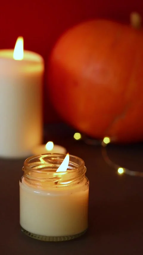 Vertical Video. lighted candles with pumpking on table. Halloween atmosphere Video stock 152446507