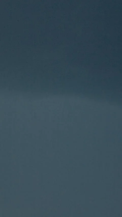 Vertical video Lightning strikes illuminate stormy skies filled with dark clouds Stock Footage 323353176