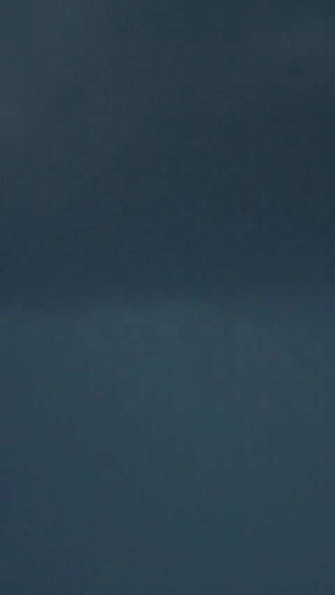 Vertical video Lightning strikes illuminate dark storm clouds in dramatic Stock Footage 323353266