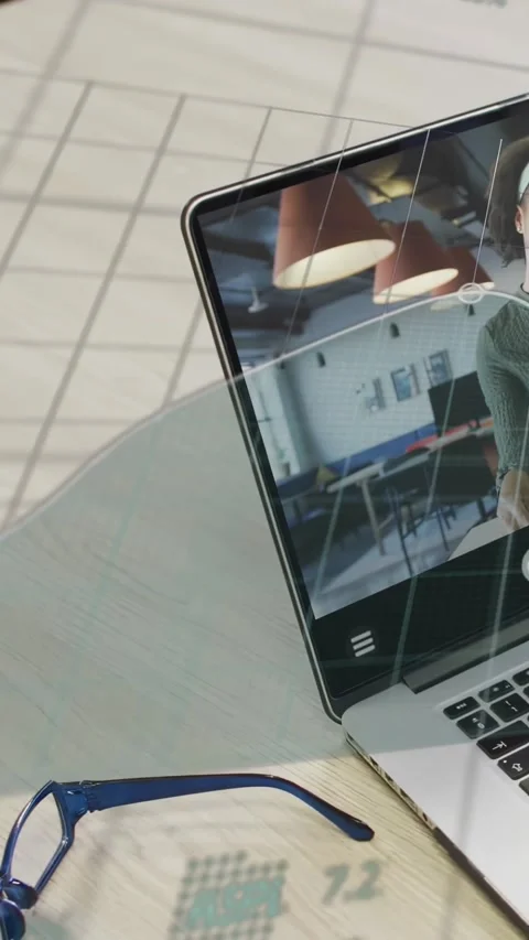 Vertical video: Live data sending overlay across laptop and desk, covering host, Stock Footage 332278562