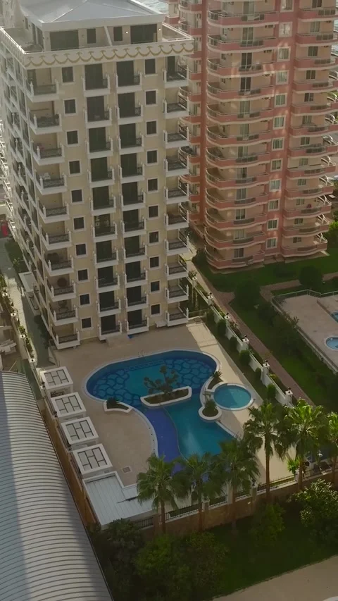 Vertical Video: Lively cityscape seen from above, highlighting high-rise Video stock 297655940