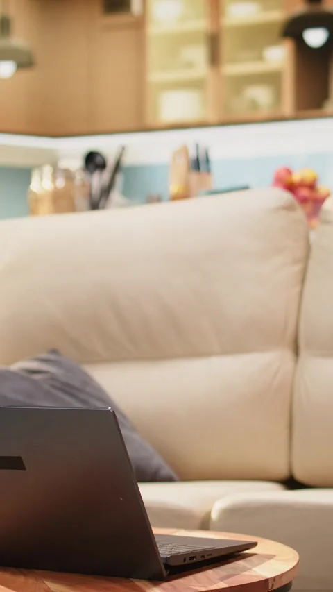 Vertical Video Living room interior with laptop placed on round coffee table Stock Footage 344528775