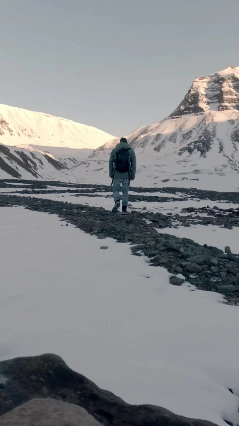 Vertical Video of Lone Hiker Exploring Remote Arctic Mountains in Svalbard Stock Footage 340036970