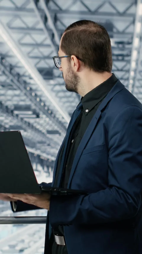 Vertical video Looking at data, laptop and portrait of cheerful man improving Stock Footage 333614378