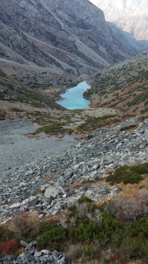 Vertical video: Low Altitude Forward Flight over Rocky Slope to Lake Stock Footage 331991881