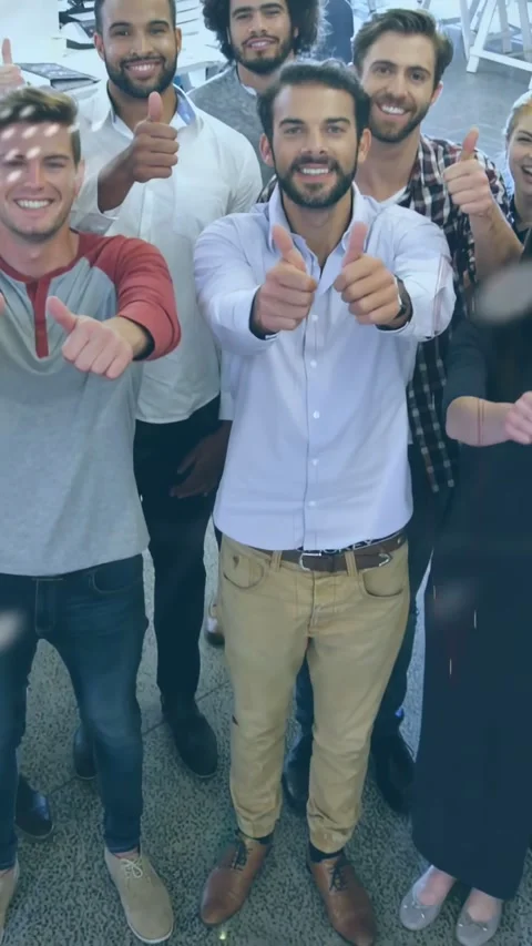 Vertical video: Low-angle camera rising, code scrolling while team showing Stock Footage 334602635