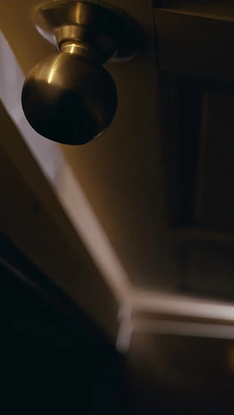 Vertical video. Low Angle View of Interior Door Slowly Opening in Dark Room Crea Stock Footage 339188968