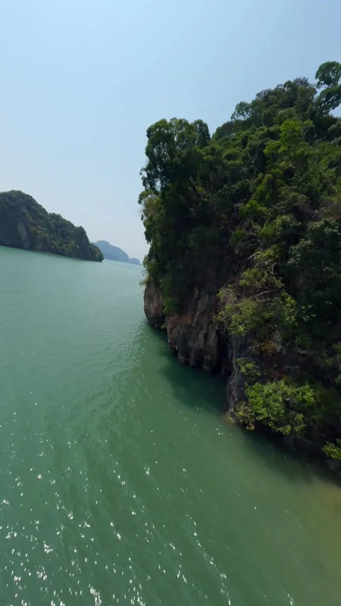 Vertical video. Low flight over empty tropical sand beach coastline sea ocean Stock Footage 245164199