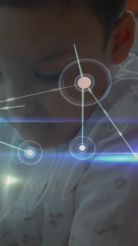 Vertical video: Lower-left flare sparking node HUD overlaying boy's face while Stock Footage 331333910