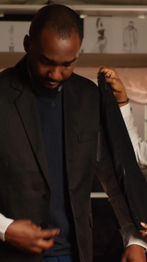 Vertical video Luxury client fitting into suit jacket Stock Footage 240847093