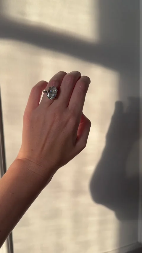 Vertical video of luxury engagement ring on hand with dramatic shadows Stock Footage 316609341