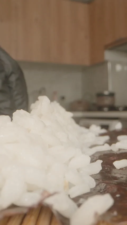 Vertical video. Macro Close-Up of a Hand in a Black Glove Distributing Sushi Vídeo Stock 304998871