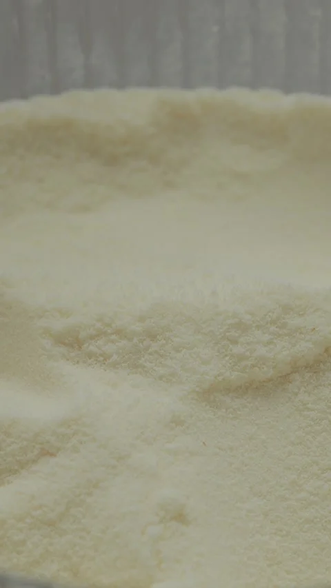 Vertical video Macro shot of fine powdered milk with smooth texture and light Stock Footage 329618708