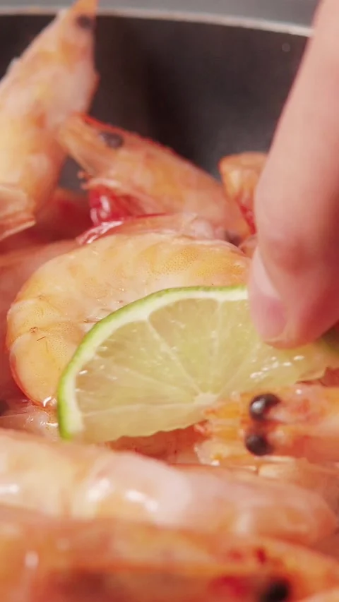 Vertical video macro shot of fresh whole prawns frying in hot pan Stock Footage 345212137