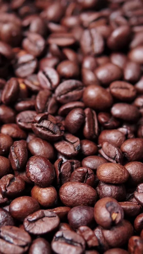 Vertical video macro shot of rich dark roasted coffee beans texture filling.. Stock Footage 345972582