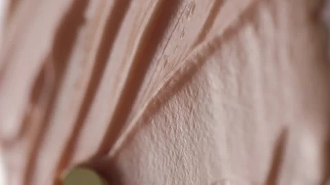 Vertical video. Macro video shooting of cosmetic cream. Beige texture. View from Stock Footage 263680908