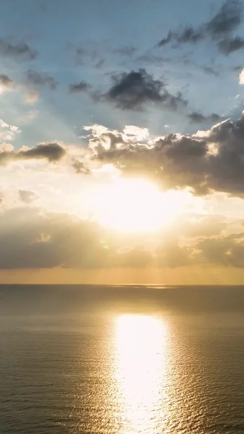 Vertical Video: Magical Sunset Over the Sea with Gentle Waves and a Sky Filled Stock Footage 297725777