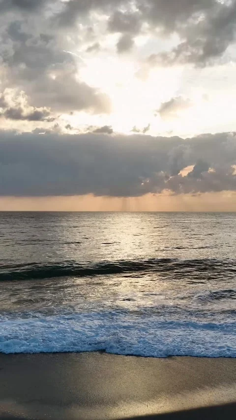 Vertical Video: Magical Sunset Over the Ocean with Textured Waves and a Sky Stock Footage 297726141
